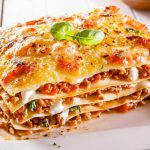 Portion of lasagne with bolognese and cheese